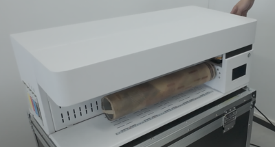 Laying protective paper onto the sock printer roller before loading a sock