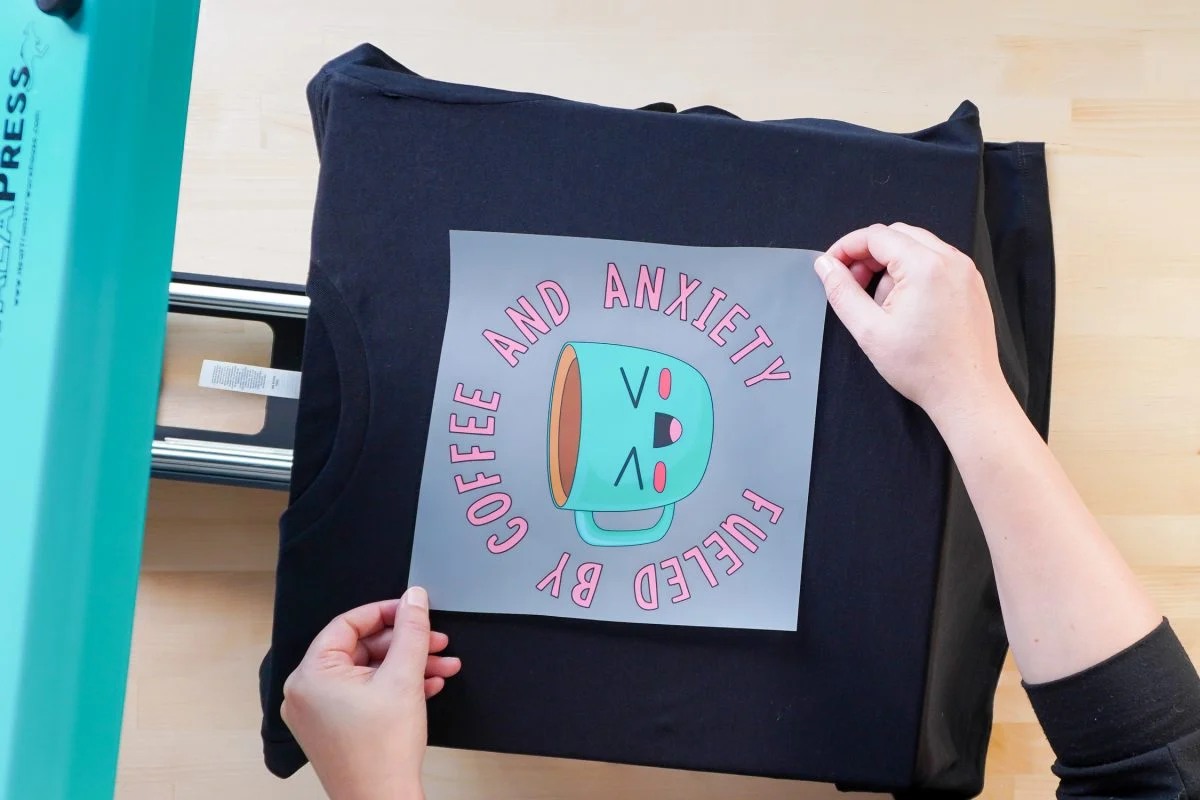 Positioning the printed DTF film face-down onto the garment